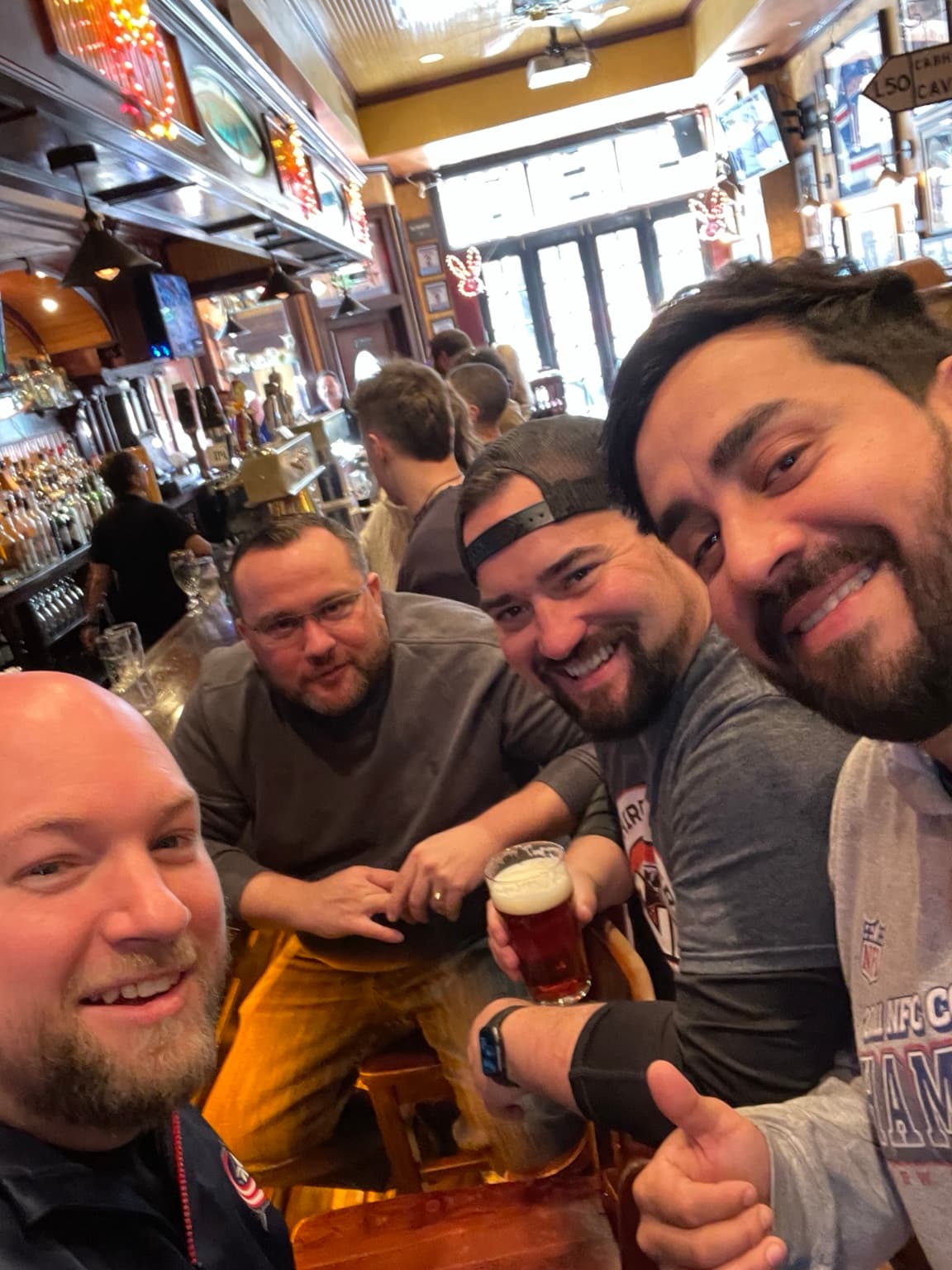 Four friends taking a selfie together at the pub